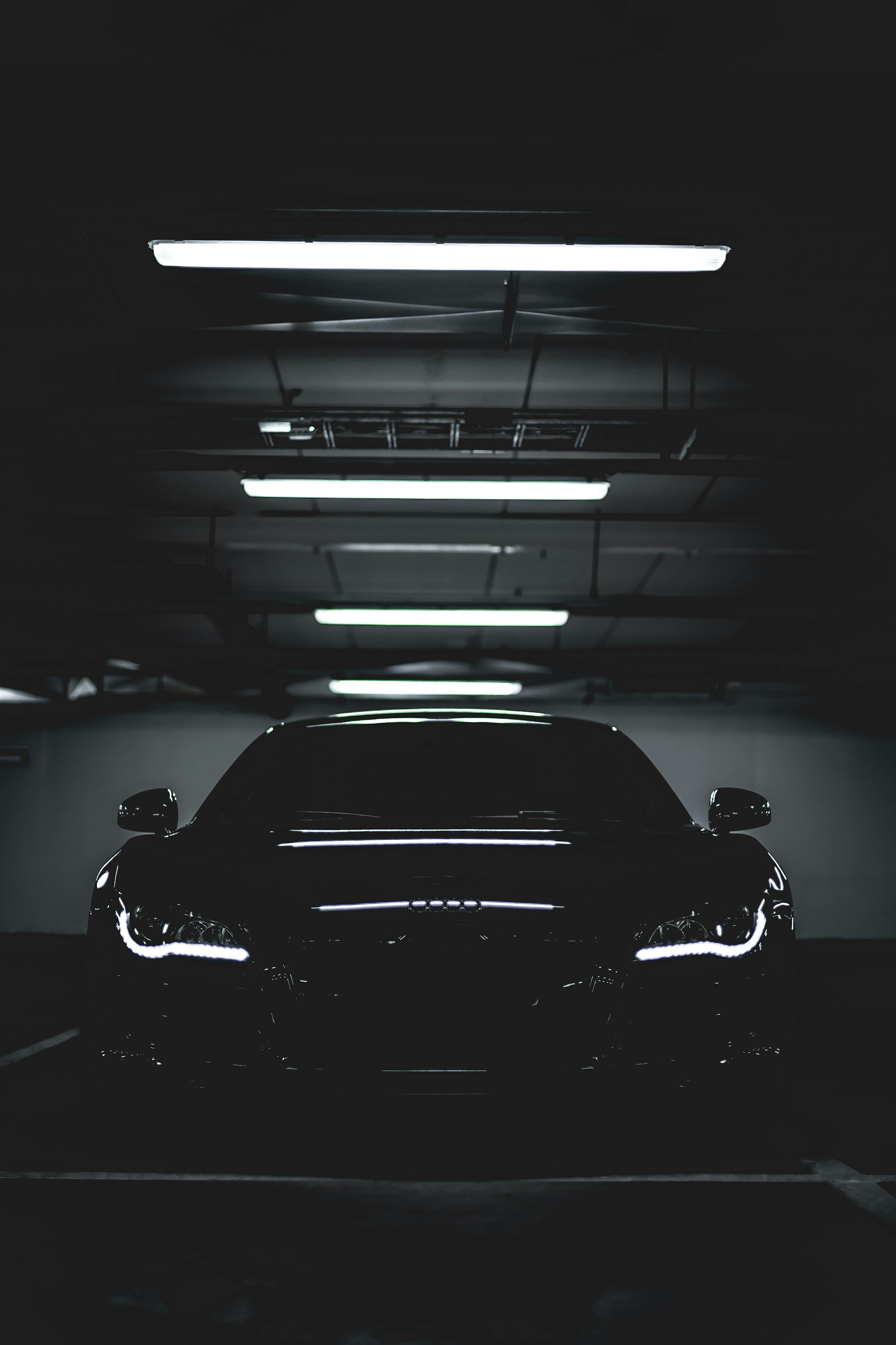 Black vehicle positioned in a professional detailing bay